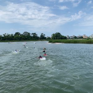 campers swimming to their boats