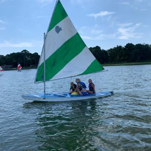 3-campers-sailing-the-green-and-white-boat-2.jpg