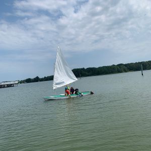 2 campers climbing aboard the green boat