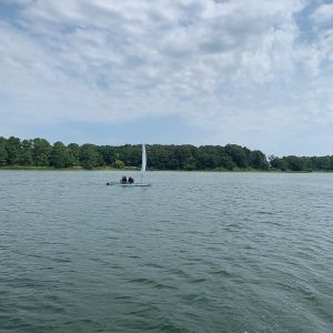 2 campers on their boat in a lull