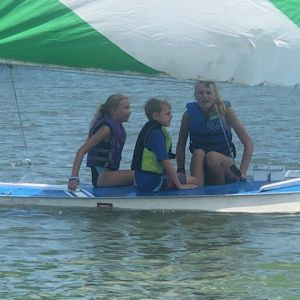 three campers in boat waiting for instruction