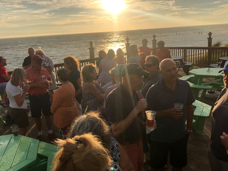 view of the fundraising crowd on the deck at sunset