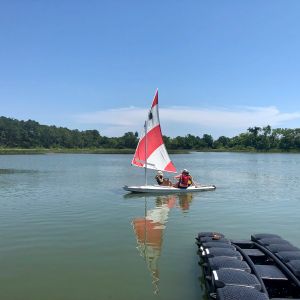 two younger sailors cast off with instructor