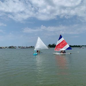 2 boats of campers going around buoy