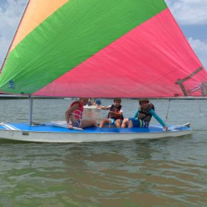 3 campers in boat on water