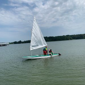 3 campers in green boat