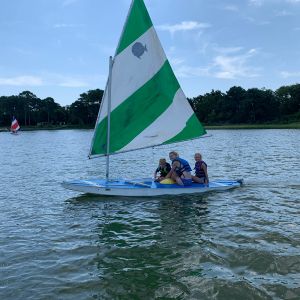 3-campers-sailing-the-green-and-white-boat.jpg